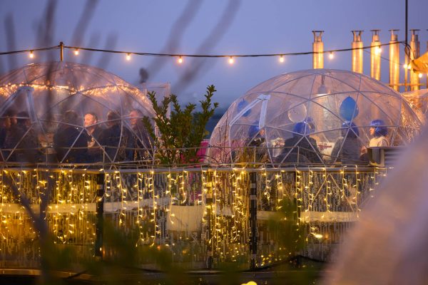 A group of friends beneath a transparent dome