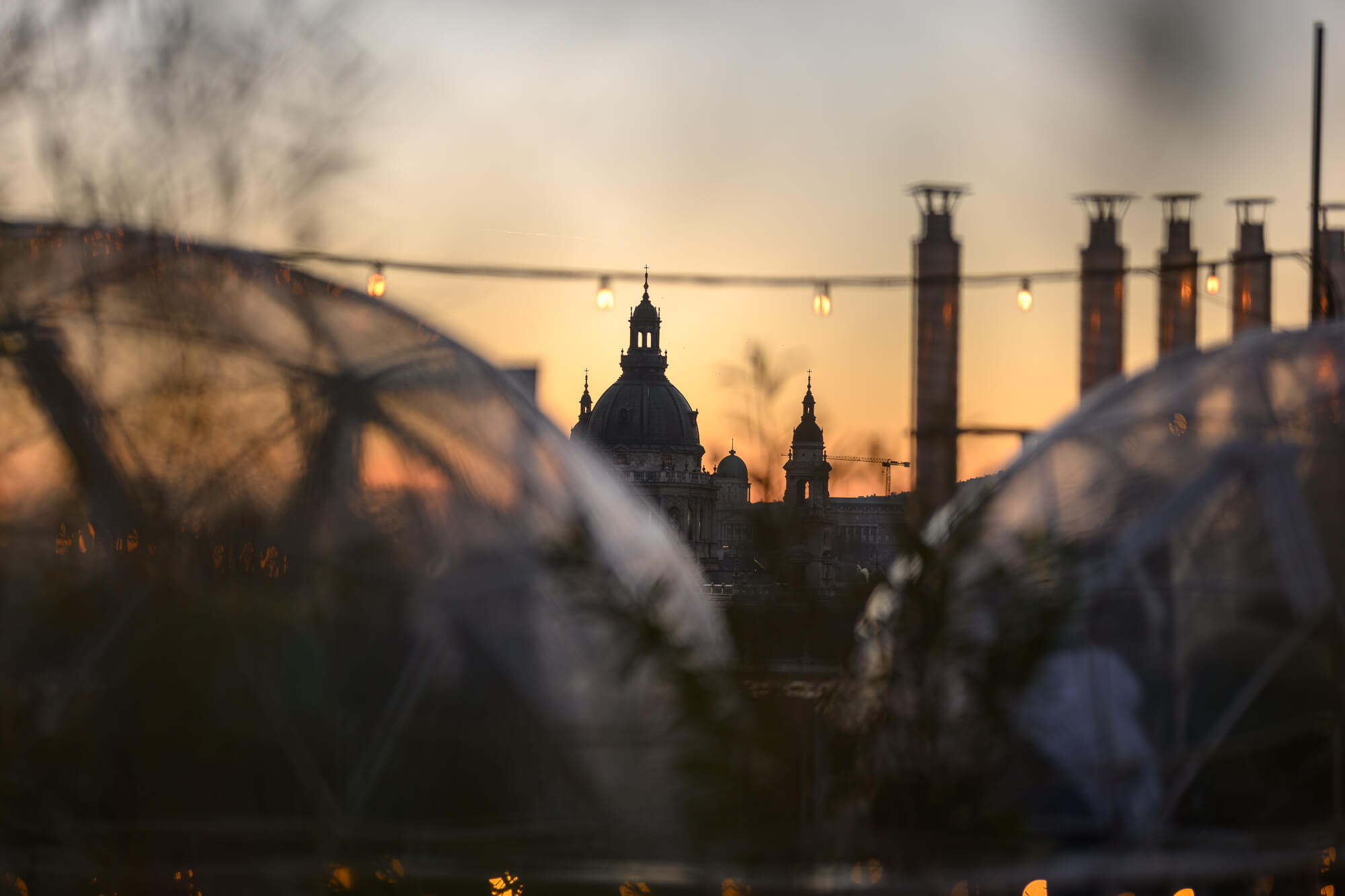 Sunset over Budapest behind the transparent domes of Igloo Garden